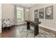 Bright office with hardwood floors, modern desk, and a comfortable accent chair at 10201 Daufuskie Dr, Charlotte, NC 28278
