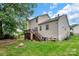 Two-story home with a wooden deck and spacious backyard, ideal for outdoor activities and relaxation at 10508 Madison Park Dr, Charlotte, NC 28269
