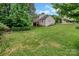 A sprawling yard behind a house is surrounded by green trees at 10508 Madison Park Dr, Charlotte, NC 28269