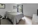Neutral bedroom features a large window and a cozy gray comforter, creating a calming atmosphere at 10508 Madison Park Dr, Charlotte, NC 28269