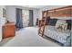 Spacious bedroom with bunk beds, desk, and carpeted floor provides a versatile living space at 10508 Madison Park Dr, Charlotte, NC 28269