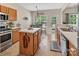 Bright breakfast nook with an island, stainless appliances and large windows overlooking the greenery at 10508 Madison Park Dr, Charlotte, NC 28269