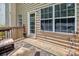 Outdoor deck with furniture, featuring a white door leading indoors and exterior lights at 10508 Madison Park Dr, Charlotte, NC 28269