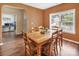 Bright dining room with wood table, chairs, wood floors, and natural light from a large window at 10508 Madison Park Dr, Charlotte, NC 28269