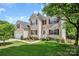 Beautiful exterior of home with a well-maintained lawn, landscaped garden beds, and an attached garage at 10508 Madison Park Dr, Charlotte, NC 28269