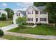 Charming two-story home with tan siding, maroon shutters, well-manicured lawn, and lush landscaping at 10508 Madison Park Dr, Charlotte, NC 28269