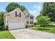 Exterior of the home featuring an attached two-car garage and meticulously kept landscaping at 10508 Madison Park Dr, Charlotte, NC 28269