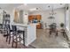 Eat-in kitchen features a breakfast bar and a cozy dining area with a chandelier at 10508 Madison Park Dr, Charlotte, NC 28269