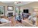 Comfortable living room featuring a fireplace, large windows, and wood floors at 10508 Madison Park Dr, Charlotte, NC 28269