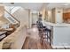 Open living area features wood floors, kitchen bar, and staircase to upper level at 10508 Madison Park Dr, Charlotte, NC 28269
