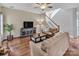 Cozy living room area with a staircase, wood floors, and neutral wall color at 10508 Madison Park Dr, Charlotte, NC 28269