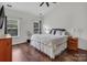 Bright bedroom with wood floors, a ceiling fan, and two windows with blinds at 10508 Madison Park Dr, Charlotte, NC 28269