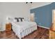 Spacious bedroom with wood floors, blue accent wall, and neutral furniture at 10508 Madison Park Dr, Charlotte, NC 28269