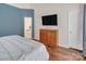 Bedroom features an en suite bathroom, wooden floors, and neutral walls at 10508 Madison Park Dr, Charlotte, NC 28269
