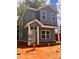 Exterior view of two-story house showcases gray siding, white trim, and front yard with open utility connections at 115 Allen St, Rock Hill, SC 29730