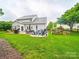 Expansive backyard with a stone patio, outdoor seating, and well-maintained lawn at 1151 Gower St, Fort Mill, SC 29708