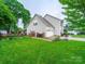 Home's backyard with a spacious lawn, white garage, and full basketball court for outdoor fun at 1151 Gower St, Fort Mill, SC 29708