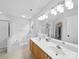 Bright bathroom features a double sink vanity, a soaking tub, and a glass-enclosed shower, providing a spa-like experience at 1151 Gower St, Fort Mill, SC 29708