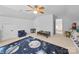 Bright, spacious bedroom features a galaxy-themed rug and cozy seating, perfect for play and relaxation at 1151 Gower St, Fort Mill, SC 29708