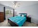 Serene bedroom with teal bedding, dark furniture, and a large window offers a calm and inviting space at 1151 Gower St, Fort Mill, SC 29708
