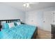 Bedroom with light blue walls with teal bedding, dark furniture, and a ceiling fan at 1151 Gower St, Fort Mill, SC 29708