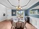 Elegant dining room with wainscoting, chandelier, and a round table perfect for Gathering meals at 1151 Gower St, Fort Mill, SC 29708