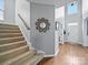 Welcoming foyer featuring hardwood floors, a staircase, and a decorative mirror at 1151 Gower St, Fort Mill, SC 29708