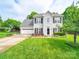 Charming two-story home featuring a well-manicured lawn, attached garage, and inviting entrance at 1151 Gower St, Fort Mill, SC 29708