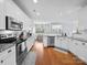 Bright kitchen featuring stainless steel appliances, white cabinets, and granite countertops at 1151 Gower St, Fort Mill, SC 29708