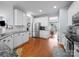 Spacious kitchen featuring stainless steel appliances, white cabinets, granite countertops, and hardwood floors at 1151 Gower St, Fort Mill, SC 29708