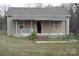 Quaint single-story home featuring a covered porch, light siding, and a well-maintained roof at 120 Mccleave Rd, China Grove, NC 28023