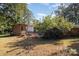 The home's backyard offers an outdoor seating area and a serene setting with mature plantings and a brick exterior at 1239 Christopher Cir, Rock Hill, SC 29730
