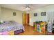 Bright bedroom with hardwood floors, a ceiling fan, and an open view to a bathroom through a door at 1239 Christopher Cir, Rock Hill, SC 29730