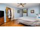 Cozy bedroom featuring hardwood floors, a ceiling fan, and a colorful quilt on the bed at 1239 Christopher Cir, Rock Hill, SC 29730