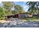 Cozy brick home with mature trees, covered carport, and a well-maintained front yard at 1239 Christopher Cir, Rock Hill, SC 29730