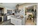Well-equipped kitchen featuring tiled backsplash, an island cooktop, and adjacent laundry area at 1239 Christopher Cir, Rock Hill, SC 29730