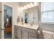Bathroom featuring a double sink vanity, ample lighting, and modern fixtures at 13624 Jacks Ln, Pineville, NC 28134