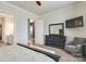 Bedroom with ensuite bath and tv; features include dark wood furniture and gray walls at 13624 Jacks Ln, Pineville, NC 28134