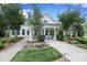 Exterior view of the clubhouse with columns and manicured landscaping at 13624 Jacks Ln, Pineville, NC 28134