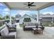 Inviting covered patio featuring plush seating, a ceiling fan, and a view of the backyard at 13624 Jacks Ln, Pineville, NC 28134