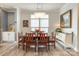 Dining room with wood table and chairs illuminated by a modern chandelier and natural light at 13624 Jacks Ln, Pineville, NC 28134