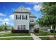 Charming two-story home with light-blue siding, black shutters, manicured landscaping, and inviting front porch at 13624 Jacks Ln, Pineville, NC 28134