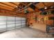 Bright and spacious garage featuring a large roll-up door, storage shelves and ample workspace at 13624 Jacks Ln, Pineville, NC 28134