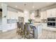 Bright kitchen featuring white cabinets, granite countertops, stainless steel appliances, and a center island with bar seating at 13624 Jacks Ln, Pineville, NC 28134