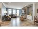Spacious living room featuring a stone fireplace, hardwood floors, comfortable seating, and ample natural light at 13624 Jacks Ln, Pineville, NC 28134