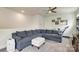 Spacious living area with a large sectional sofa and ample natural light at 13624 Jacks Ln, Pineville, NC 28134