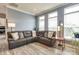 Comfortable living room with large windows and a plush sectional sofa, perfect for relaxing at 13624 Jacks Ln, Pineville, NC 28134