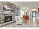 Cozy living space showcases a stone fireplace, hardwood floors, an open layout, and elegant dining area at 13624 Jacks Ln, Pineville, NC 28134