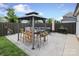 Outdoor dining area features a modern gazebo, comfortable seating, and a paved patio at 13624 Jacks Ln, Pineville, NC 28134