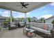Inviting covered patio featuring comfortable seating, ceiling fan, and neighborhood views, perfect for outdoor relaxation at 13624 Jacks Ln, Pineville, NC 28134